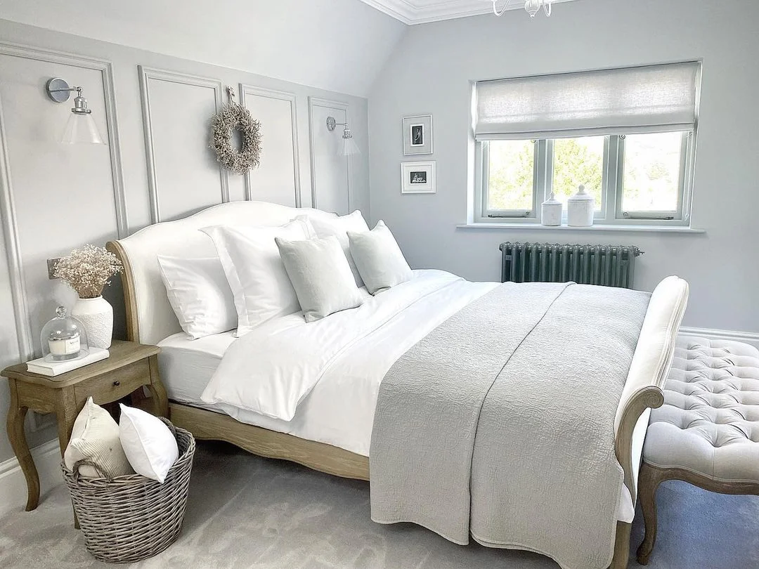 Pale grey bedroom with painted panelling in a French country style