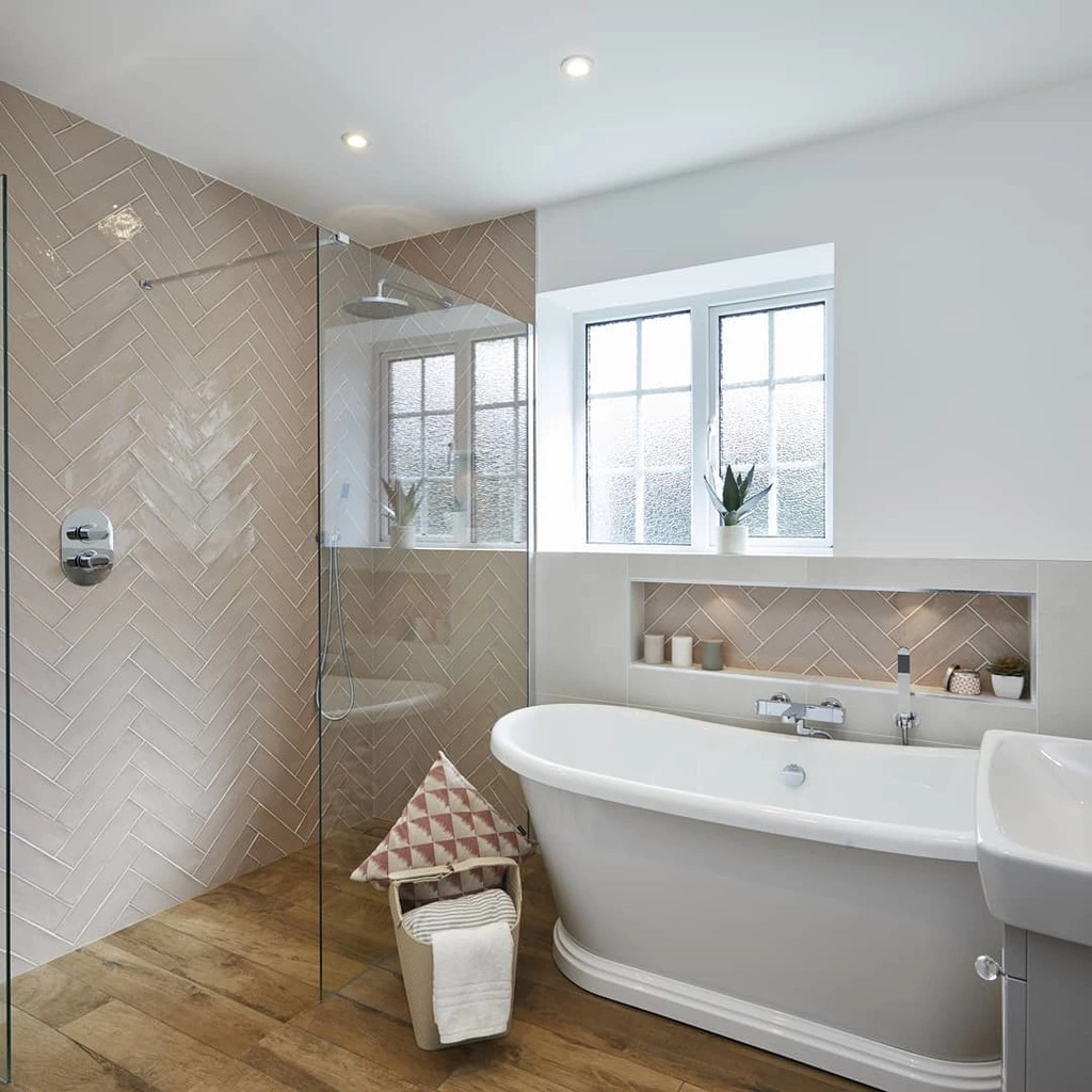 Walk-in shower in a small wet room bathroom with large format tiles