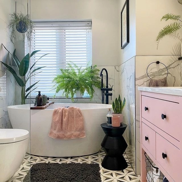 Small bathroom with compact freestanding bath and colourful wall tiles