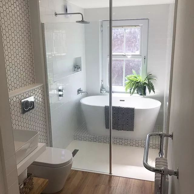 Small bathroom layout incorporating a separate bath with green wall tiles