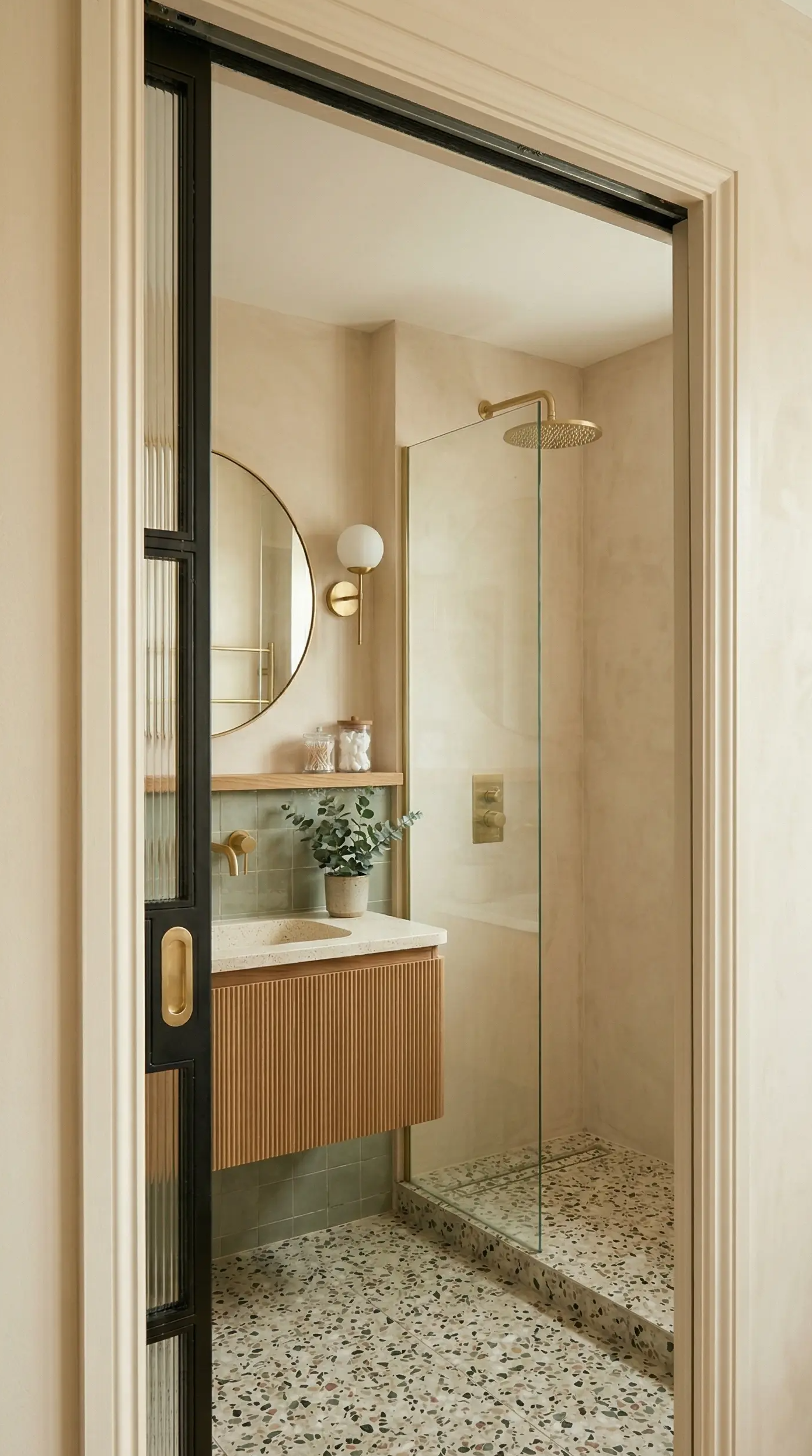 Small bathroom with terrazzo floor tiles and a space-saving pocket door