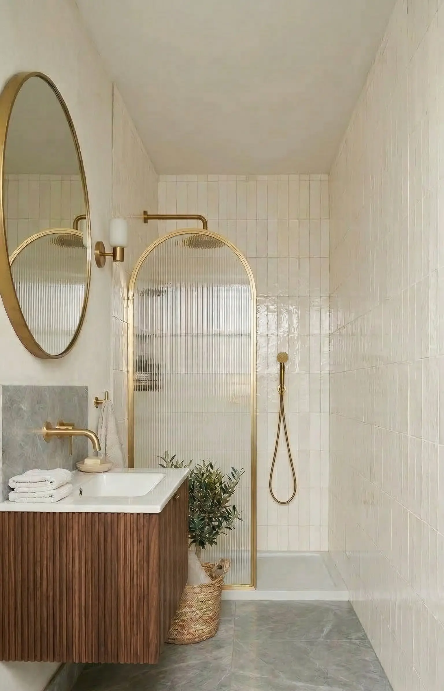 Walk-in shower in a small bathroom with frameless glass panel saving space