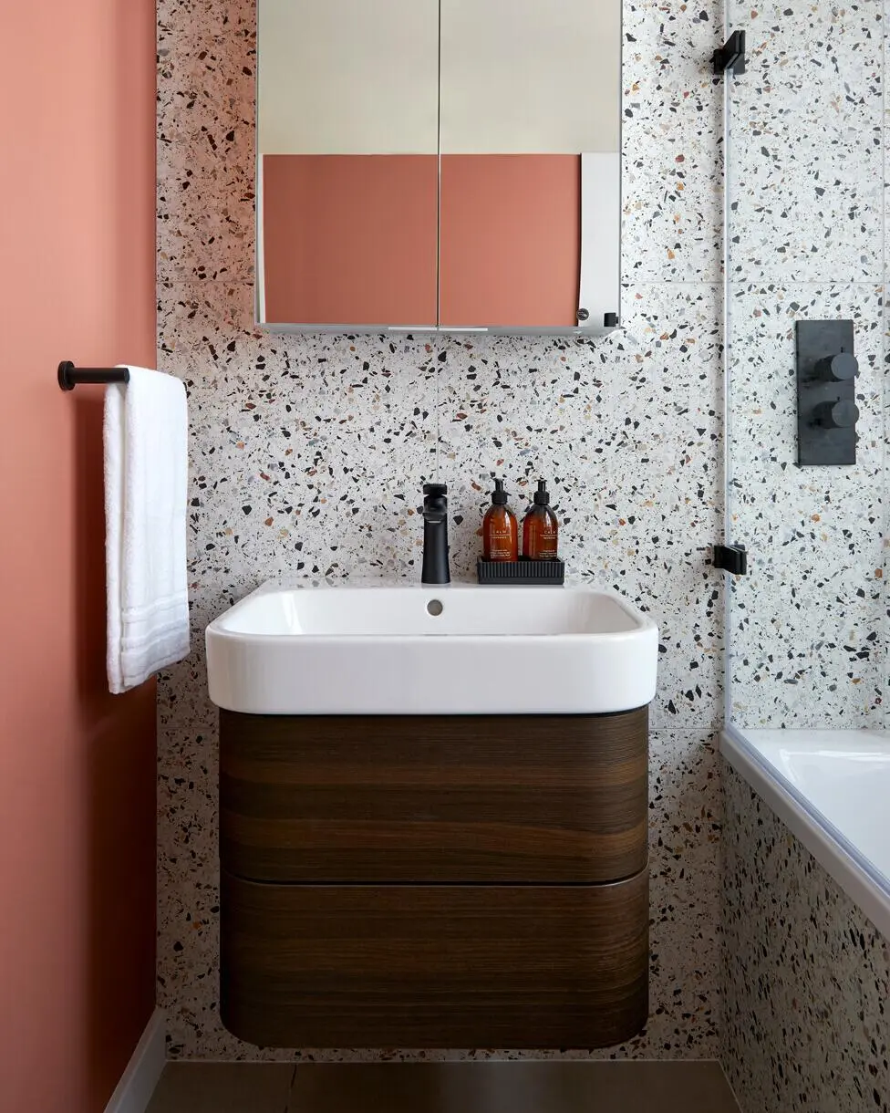 Mirrored wall cabinet above basin in a small bathroom providing hidden storage