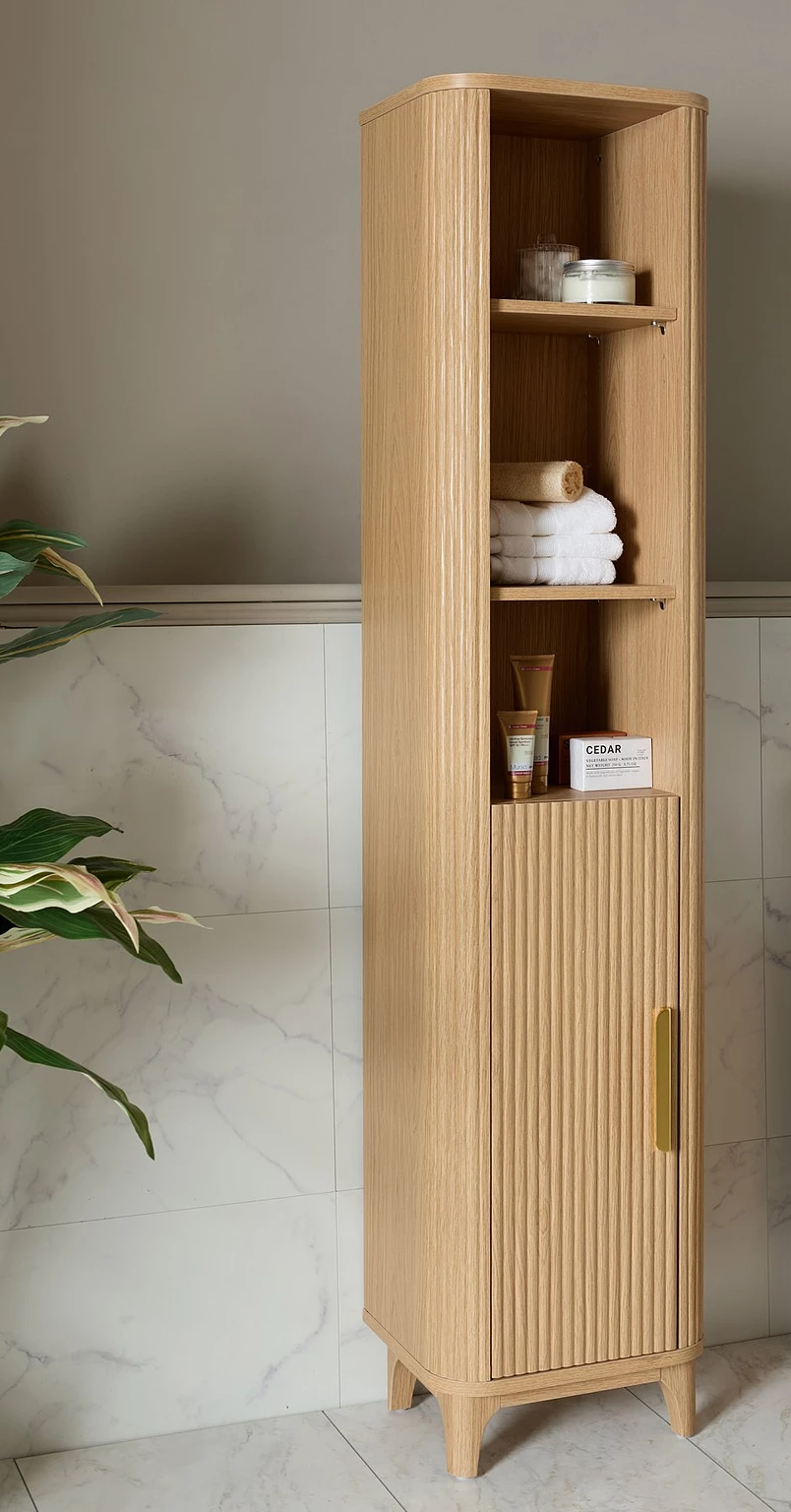 Tall narrow oak storage cabinet with fluted detail for small bathrooms