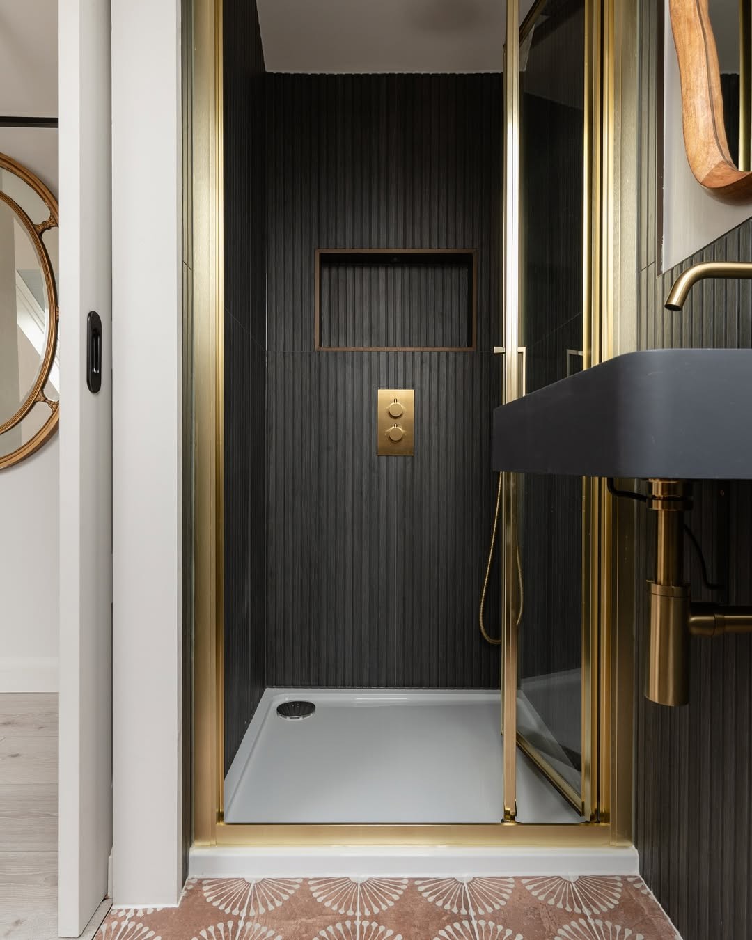 Small bathroom with warm brushed brass metallics and black details