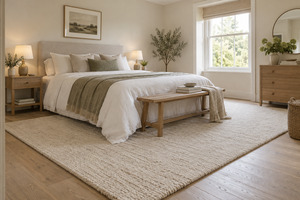 A bedroom rug should feel comfortable underfoot, sit safely around furniture and support the room palette without overwhelming it.